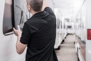 RV Travel Trailers Specialist Performing Windows Seals Check