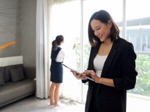 Asian,Businesswoman,In,Black,Suit,Standing,With,Tablet,Computer,In