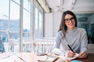 Cheerful,Hipster,Girl,Working,As,Journalist,Enjoying,Leisure,At,Cafeteria