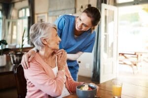 Healthcare,,Elderly,Woman,With,Nurse,With,Breakfast,At,Her,Home