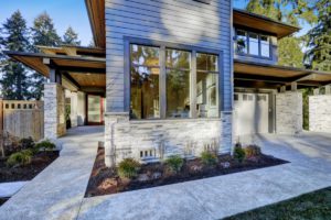 Entrance,Of,Luxurious,New,Construction,Home,With,Blue,Siding,And